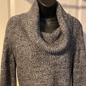 Black and white cowl neck sweater dress with two patch pockets.